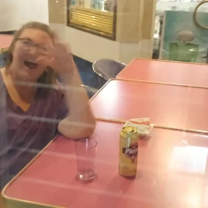 Katja sitzt im Restaurant und wurde von mir von draußen durch die Scheibe fotografiert